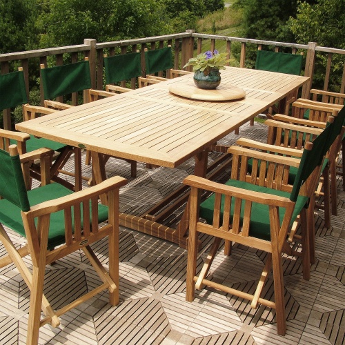 70006 Veranda teak 11 piece director chair dining set potted violet plant on teak lazy susan on teak floor deck with trees in background