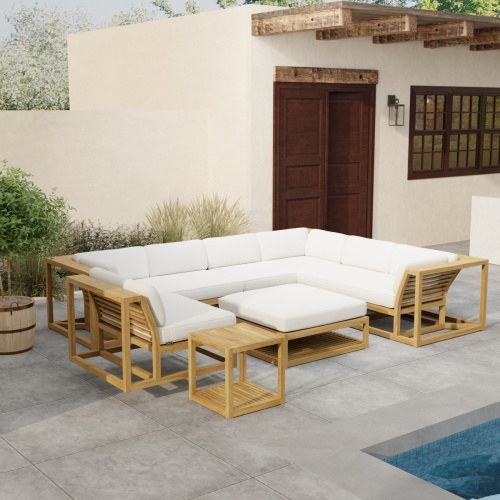 70273 Maya 6pc Sectional Set side angled on patio next to a pool with landscaping plants a door and window of house in background 