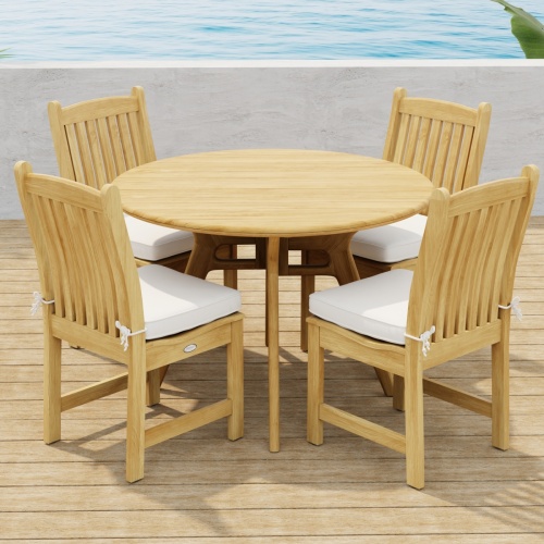 70356 Veranda Surf 5 pc Cafe Dining Set showing a Surf 42 inch round dining table and 4 Veranda Side Chairs with optional seat cushions side angled view on wood deck with ocean background  