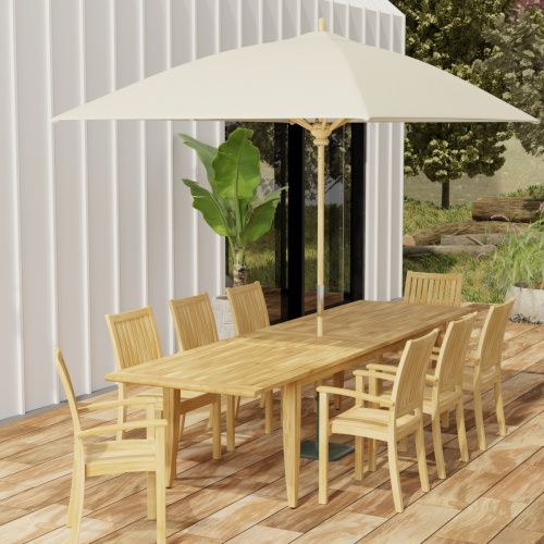 70774 Laguna Sussex 9 pc Teak Dining Set with optional umbrella in angled end view on patio with potted tree and house in background