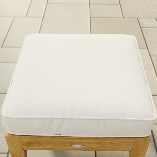  72324MTO Laguna Ottoman Cushion with Quick Dry Foam Core showing angled top view on the Laguna Ottoman Teak Frame on tiled patio