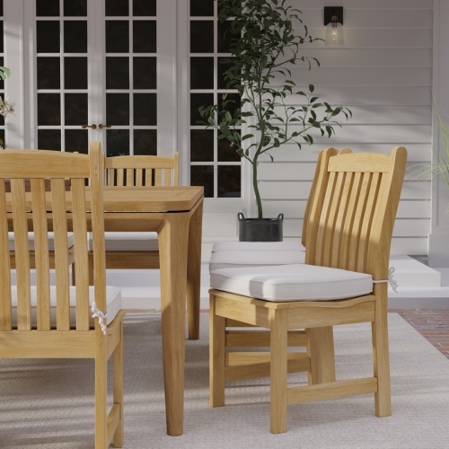 11315 Veranda Teak Side Chair with optional seat cushion on patio with wall and french doors in the background