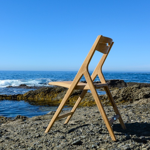 11916 Surf folding Side Chair left side view on beach facing ocean and blue sky background 