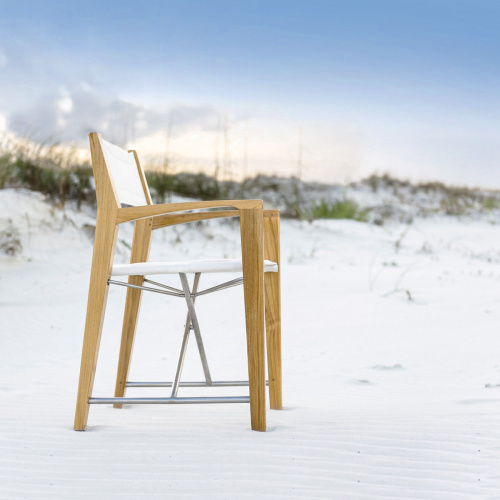 12915F Odyssey Director Chair right side view facing ocean on sandy beach with sand dunes and sea grass and blue sky in background