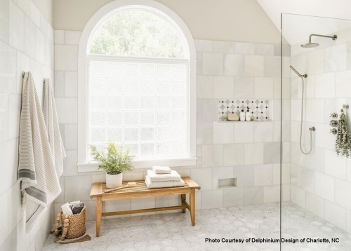 13916 Laguna Teak 5 foot Backless Bench inside a shower with towels on bench
