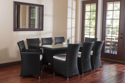 32001BK Valencia Rectangular Dining Table with Valencia 9 piece dining set side angled view on wood floors with wall mirror and patio doors to outside in background