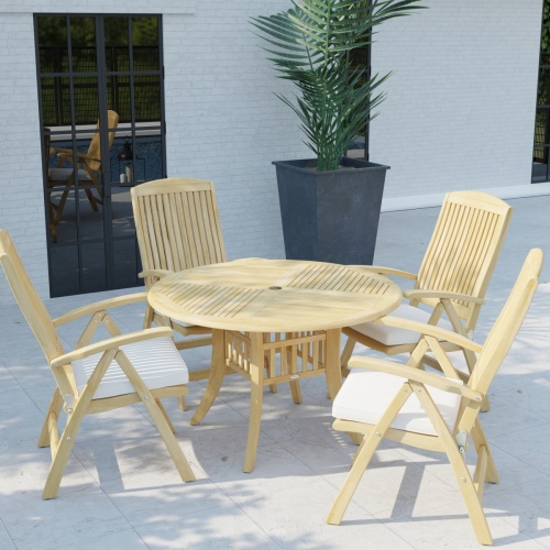 70025 Hyatt Recliner Dining Set with Seat Cushions in angled side view on tiled stone patio next to a potted tree with a door and window of house in background