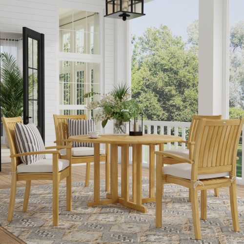 70033 Sussex Barbuda 5 piece teak Dining Set with optional canvas colored seat cushions and 2 throw pillows on carpet wood floor patio with vase and coffee cup on table with trees in back