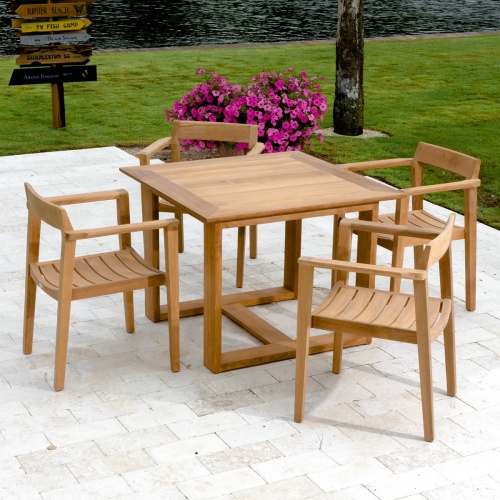 70174 Horizon 5 piece Square Dining Set on paver deck with potted flowering plant and grass and trees in background with lake view