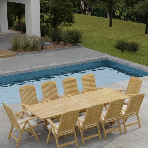 70205 Reclining 11 pc Teak Dining Set of Grand Veranda Rectangular Dining Table and 10 Barbuda Folding Armchairs with optional seat cushions in angled aerial view with pool and trees in background