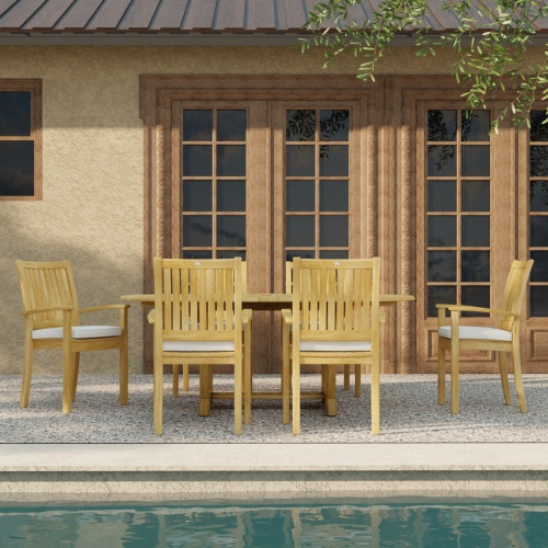 70214 Martinique Sussex Teak 7 pc Dining Set with optional seat cushions in side view next to pool with French doors of house in background