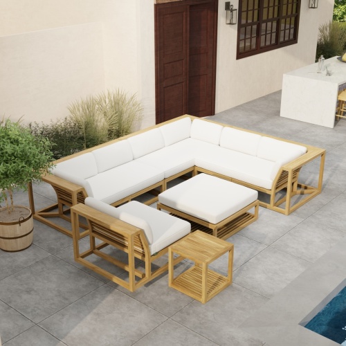 70273 Maya 6pc Sectional Set side angled aerial view on patio next to a pool with landscaping and potted plants with a door and window of house and outdoor bar in background 