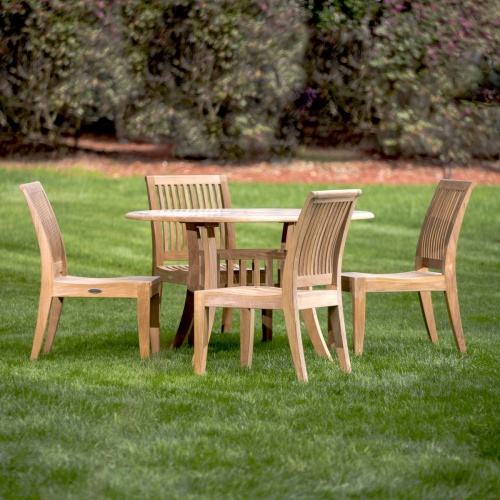 70291 Hyatt Laguna teak  5 piece Dining Set on grass lawn with mulched landscaped area of shrubs and trees in background