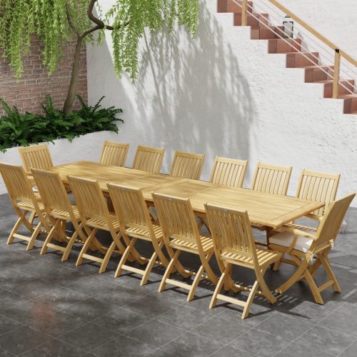 70351 Laguna Barbuda 15 pc Dining Set of 14 dining armchair and rectangular 11 foot extendable dining table angled aerial view on patio with staircase and plants in background