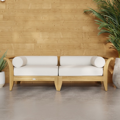 70429 Aman Dais Teak 2 pc Loveseat Set of 2 Aman Dais Corner Sectionals with cushions in front view on patio next to 2 potted plants against a wall in background
