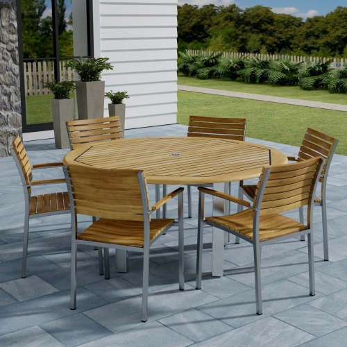70442 Vogue Teak 7 pc Dining Set showing Vogue 60 inch Round Dining Table and 6 Dining Chairs angled side view on patio with window and fence with trees in background 