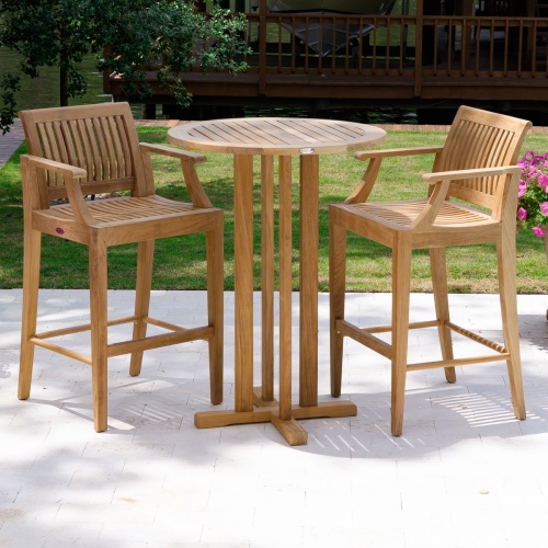 70505 Laguna 3 piece round Bar Set on concrete patio with grass lake view and screened boat house in background