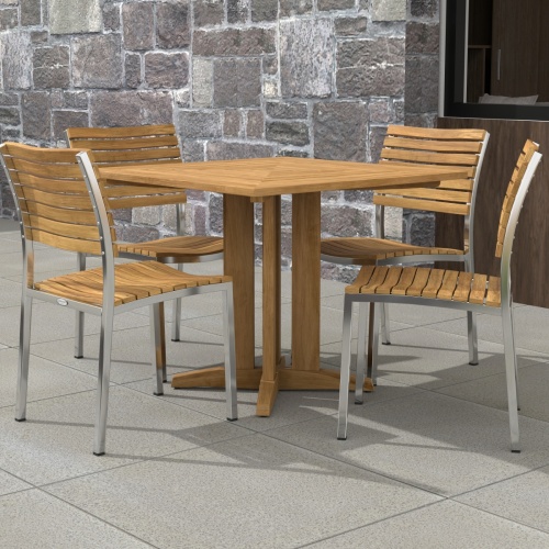 70574 Vogue Pyramid 5 pc Cafe Set of Pyramid Dining Table and 4 Vogue Side Chairs on tiled patio with stone wall and window in the background