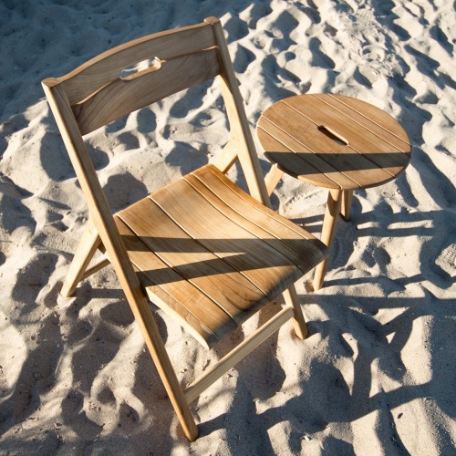 70677 surf teak folding chair and side table two piece set on sand