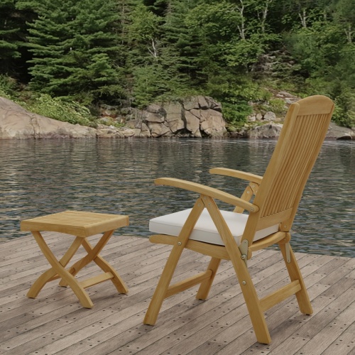 70706 Barbuda Teak Recliner & Ottoman Side Table Set showing Barbuda Recliner Teak Armchair with Optional Seat Cushion in side view on dock with lake and trees in background 