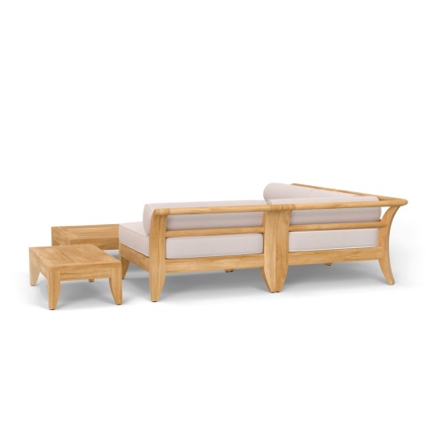 70822 Aman Dais 5 piece teak Daybed Set of 2 End Sectionals and 1 Corner Sectional and a teak coffee and side table on wood patio against a wall with railing and ocean in background