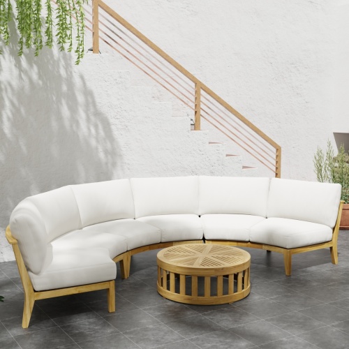 70869 Kafelonia 4 pc Round Sofa Set of 3 Kafelonia Sofa Sectional Benches and 36 inch round Coffee Table in angled front view next to potted plant on tiled patio in front of staircase
