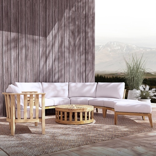 70929 Kafelonia 6 piece Sofa Sectional Set angled front view on outdoor patio in front of building next to 2 potted plants with mountains in background