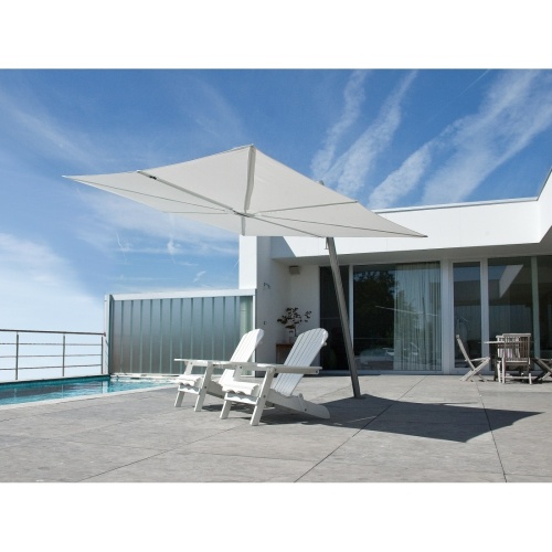 SP25100SET Spectra Solo Umbrella and Paver Base with two Adirondack chairs on concrete paver deck set pool view blue sky railing fence house and glass door in background 