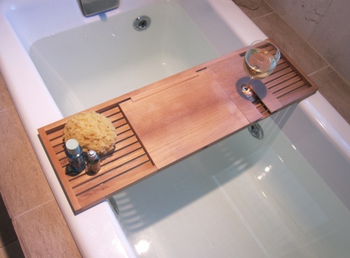 18816 Pacifica teak Bathtub Tray aerial view showing toiletries body sponge glass of wine sitting on a tub