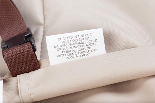 61001DP Malaga Deep Seating Armchair Cover showing closeup of label and securing clasp of the cover 