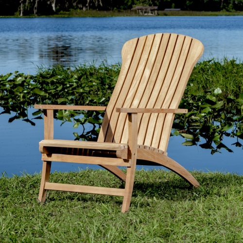 70000 Adirondack Chair in front angled view on green grass with vegetation and lake background