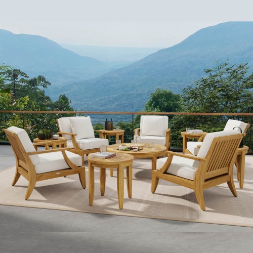70106 laguna eleven piece lounge set on stone patio with water glasses and books and cheese tray with crackers overlooking trees and mountains in background