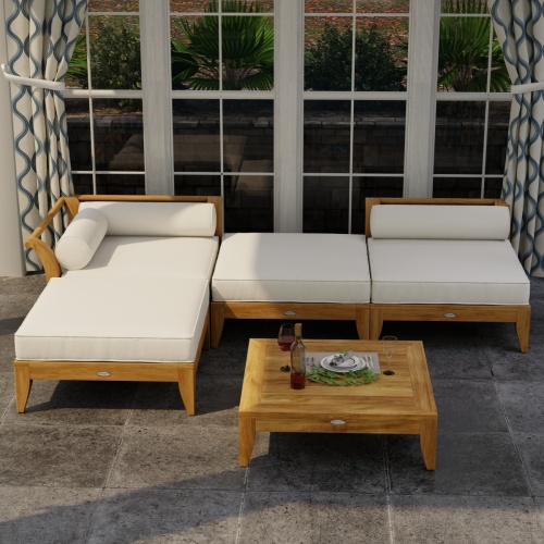 70281 Aman Dais 4 pc Lounge Sofa of 1 corner and 1 end sectional and 2 ottomans in angled front view on tile patio showing drapes and glass windows in background