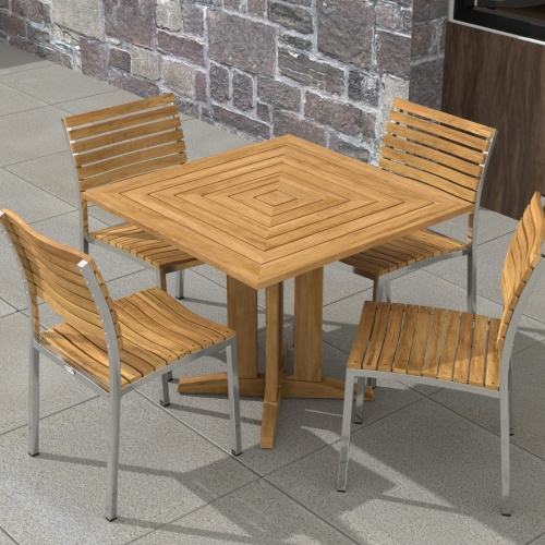 70574 Vogue Pyramid 5 pc Cafe Set of Pyramid Dining Table and 4 Vogue Side Chairs angled aerial view on tiled patio with stone wall and window in the background