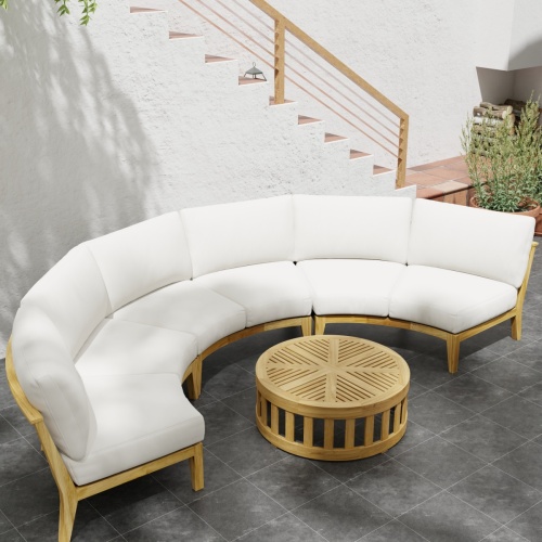 70869 Kafelonia 4 pc Round Sofa Set of 3 Kafelonia Sofa Sectional Benches and 36 inch round Coffee Table in angled top view next to potted plant on tiled patio in front of staircase 
