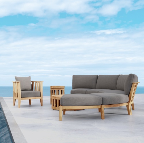 70929 Kafelonia 6 piece Sofa Sectional Set side view on outdoor patio with ocean and blue sky in background
