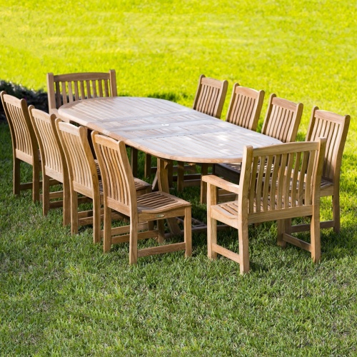 70008 Montserrat Veranda 11 piece Teak Dining Set of Montserrat Extension Table and 10 Veranda Dining Chairs on grass field 