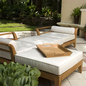 17440TO Butler teak Serving Tray on Aman Dais Sectional with trees and fireplace in background