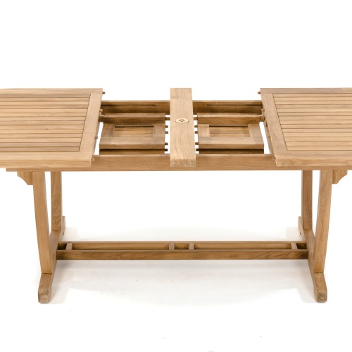70163 Montserrat teak oval dining table showing dual butterfly leaf extensions storage area top angled view on white background