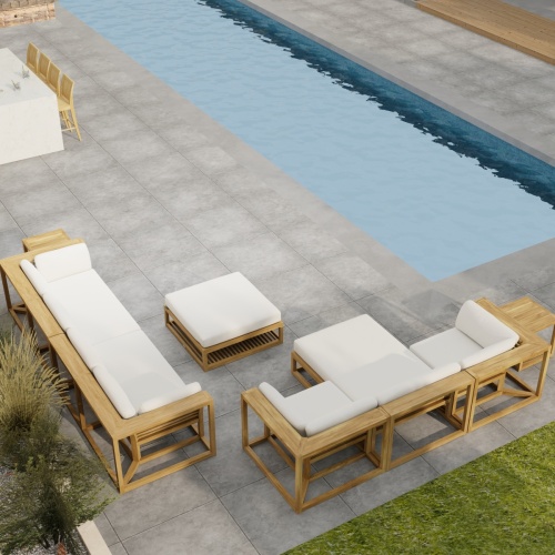70233 Maya 7 pc Sectional Furniture Set in angled aerial view on a patio next to a pool with landscape plants and a privacy wall and door in the background