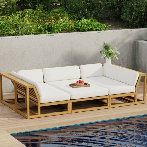 70274 Maya 3pc Daybed on patio in aerial angled side view with tray of fruit on middle daybed section facing a pool next to a potted plant with privacy wall with shrubs and trees in background