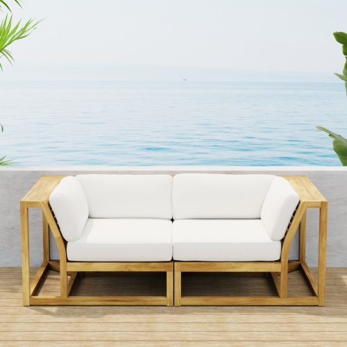 70275  Maya Love Seat of 2 Maya Corner Sectionals in angled front view on wood deck with a plant and ocean and blue sky in the background
