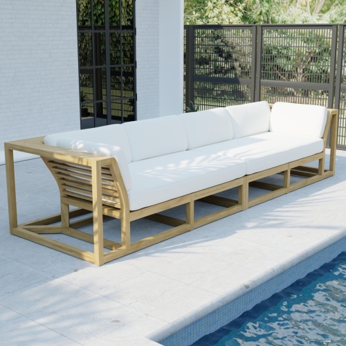 70278  Maya Grand Sofa Set of Maya Left and Right Side Sectional in angled side view on a patio facing a pool and a house with a window and a fence with trees in the background