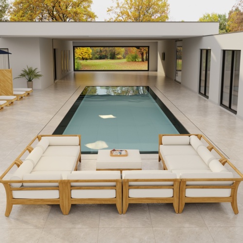 70282 Aman Dais 9 pc teak Daybed Sectional Set with bolsters and cushions angled aerial view on deck with pool and glass door of house and trees in background 