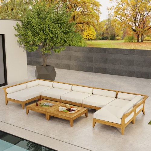 70348 Aman Dais 9 pc Lounge Set with bolsters and cushions aerial front view facing a pool  with privacy wall and trees in background