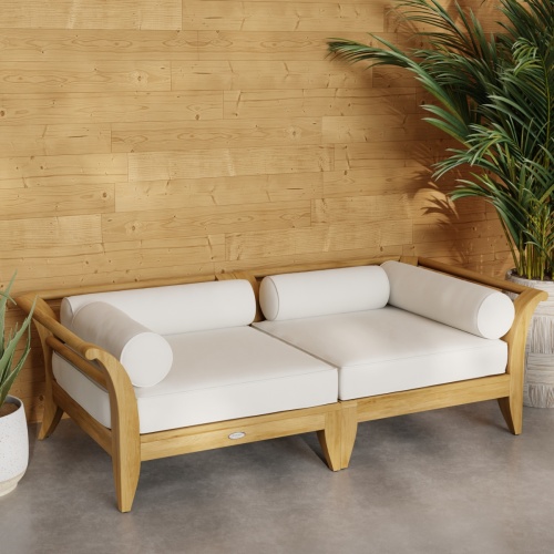 70429 Aman Dais Teak 2 pc Loveseat Set of 2 Aman Dais Corner Sectionals with cushions angled front view on patio next to 2 potted plants against a wall in background