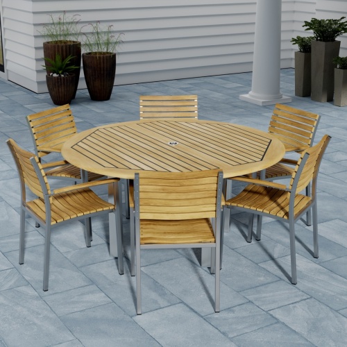70442 Vogue Teak 7 pc Dining Set showing Vogue 60 inch Round Dining Table and 6 Dining Chairs angled aerial view on patio 4 potted plants against a house in background