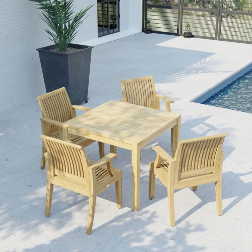 70555 Laguna 5 pc Square Dining Set of Bistro 36 inch Square Teak Dining Table and 4 Laguna Dining Armchairs in angled aerial view on patio with house pool and fence in the back