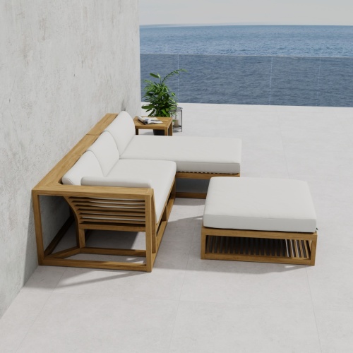 70658 Maya 4pc Lounge Set of Maya Right Side and Daybed Sectionals and Ottoman Coffee Table and Side Table  on patio against a wall in side view with ocean in background