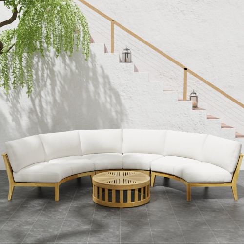 70869 Kafelonia 4 pc Round Sofa Set of 3 Kafelonia Sofa Sectional Benches and 36 inch round Coffee Table in front view next to potted plant on tiled patio in front of staircase of house
